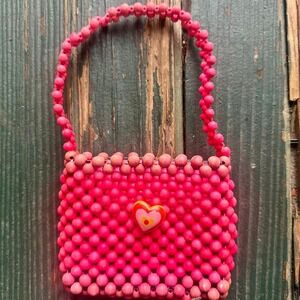 Pink and red beaded bag with heart charm